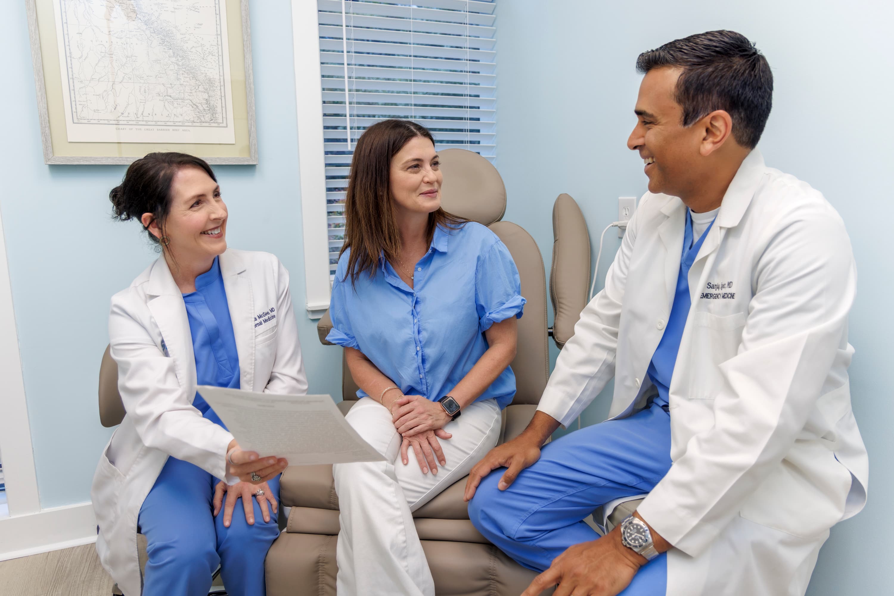Dr. Shonna McGee and Dr. Sanjay Iyer consulting with a patient at Coastal Care Vitality